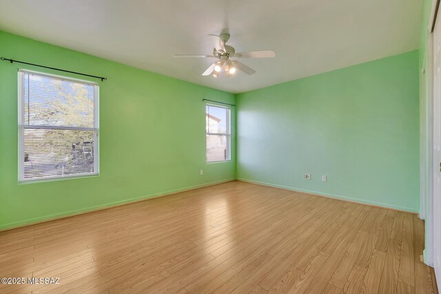 empty room with light hardwood / wood-style floors and ceiling fan