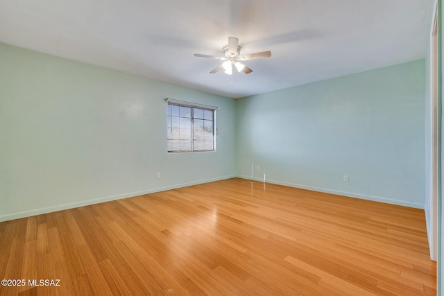 empty room featuring ceiling fan and light hardwood / wood-style floors