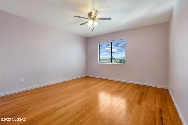 spare room with light wood-type flooring and ceiling fan