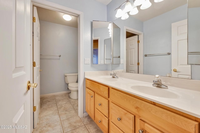 bathroom featuring tile patterned floors, vanity, and toilet