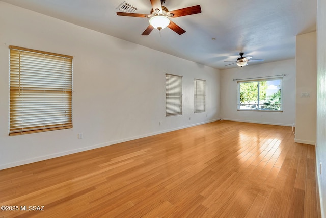 spare room featuring ceiling fan and light hardwood / wood-style flooring