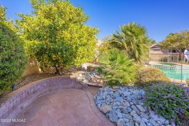 view of pool featuring a patio area and an in ground hot tub