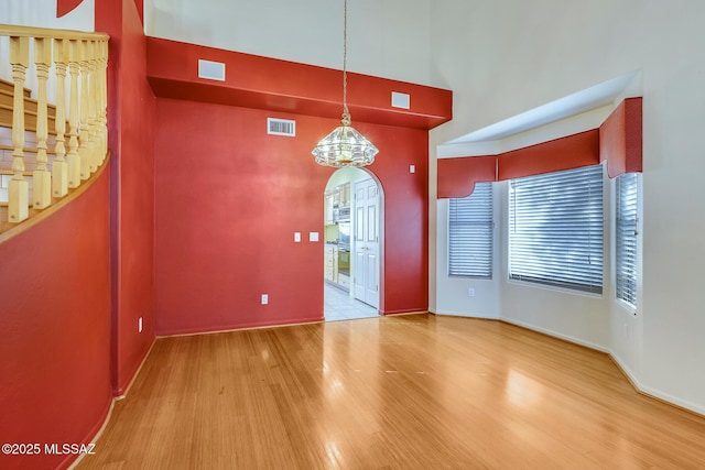 foyer entrance featuring wood-type flooring and a notable chandelier