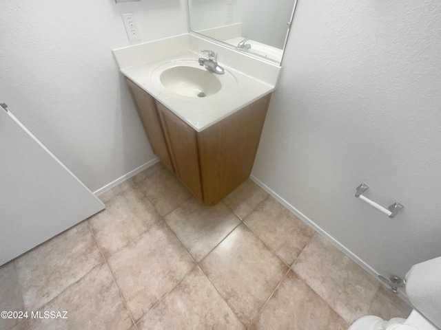 bathroom featuring tile patterned flooring and vanity