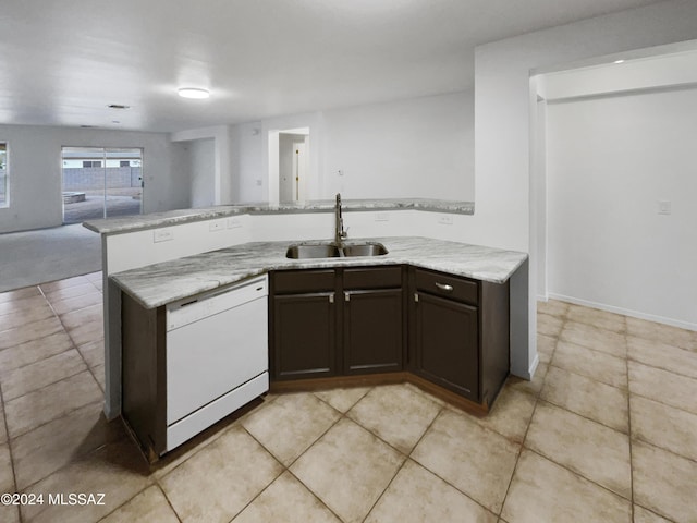 kitchen featuring white dishwasher, sink, light stone countertops, light tile patterned floors, and dark brown cabinetry