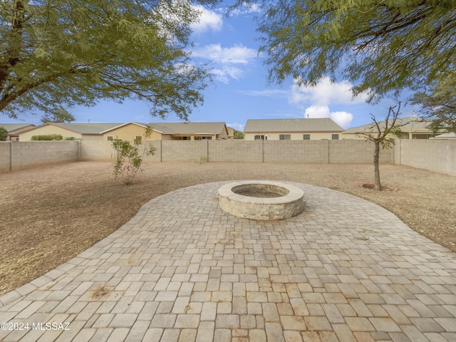 view of patio / terrace featuring an outdoor fire pit