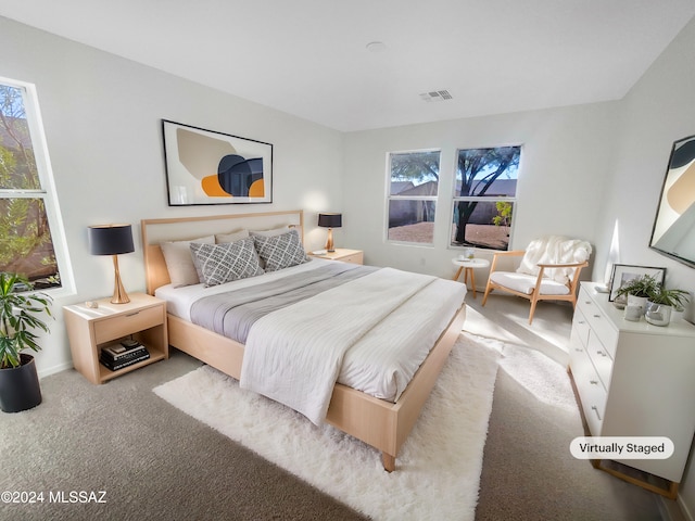 carpeted bedroom featuring multiple windows