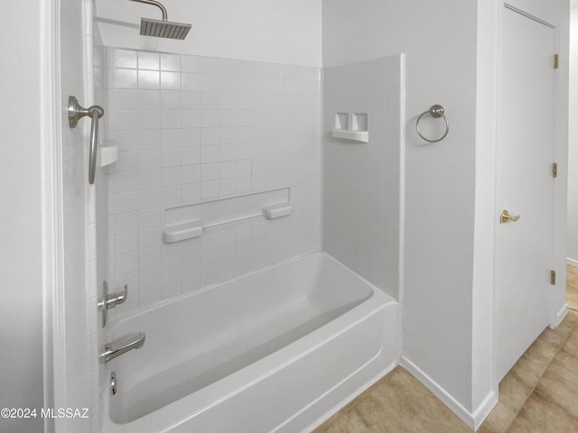 bathroom featuring tile patterned floors and tiled shower / bath