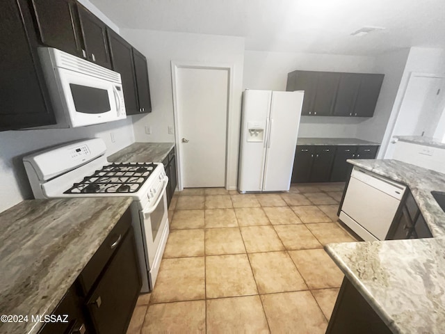 kitchen with light tile patterned flooring and white appliances