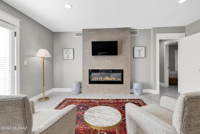 living room featuring light tile patterned floors and a fireplace