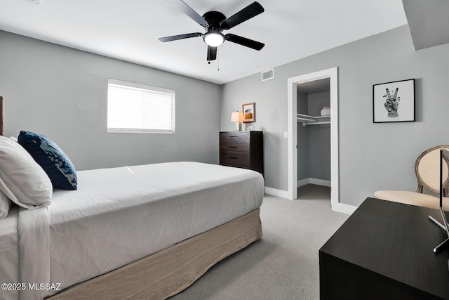 bedroom with ceiling fan, a closet, and light carpet