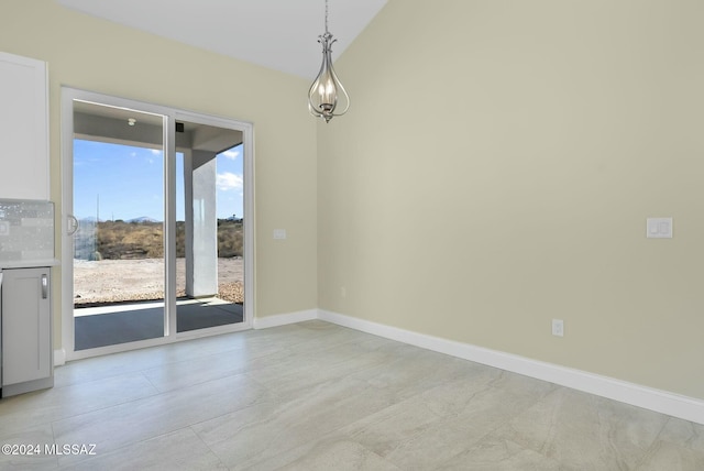 spare room with lofted ceiling