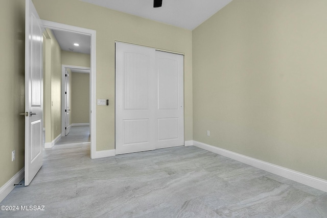 unfurnished bedroom featuring a closet and light colored carpet