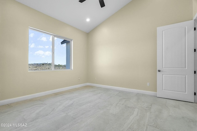 carpeted empty room with ceiling fan and vaulted ceiling