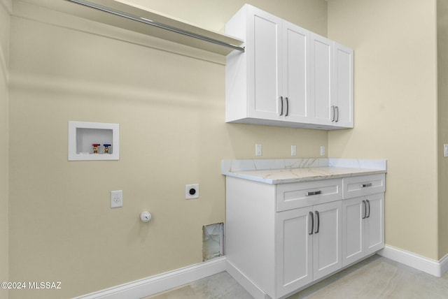 laundry area featuring hookup for an electric dryer, washer hookup, cabinets, gas dryer hookup, and light tile patterned floors