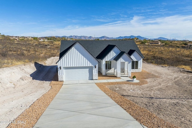 modern farmhouse style home with a mountain view and a garage