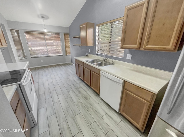 kitchen featuring lofted ceiling, white dishwasher, sink, decorative light fixtures, and light hardwood / wood-style floors