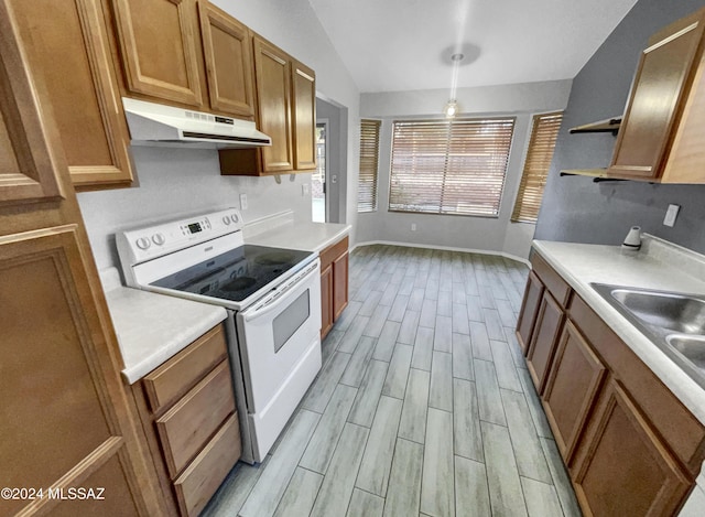 kitchen with vaulted ceiling, light hardwood / wood-style floors, white range with electric cooktop, and sink