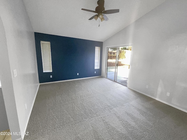 carpeted empty room with ceiling fan and vaulted ceiling