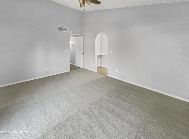 spare room featuring carpet, ceiling fan, and a textured ceiling