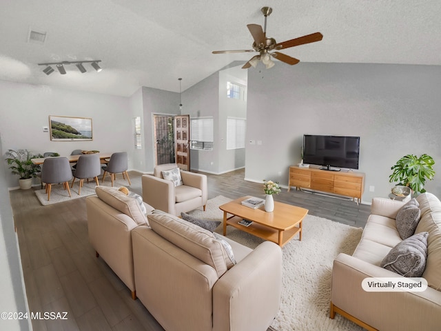 living room featuring ceiling fan, wood-type flooring, a textured ceiling, and high vaulted ceiling