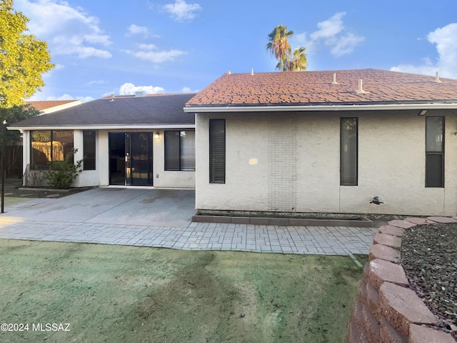 rear view of property featuring a patio