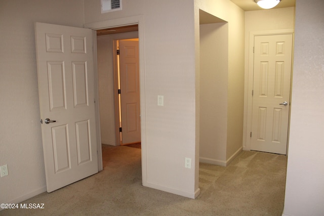 hallway with light carpet