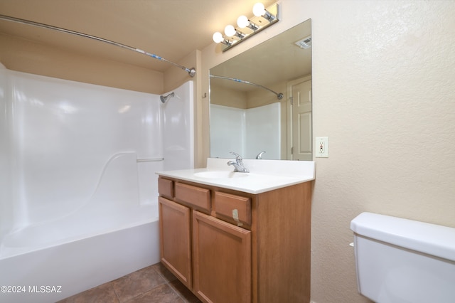 full bathroom with washtub / shower combination, tile patterned flooring, vanity, and toilet