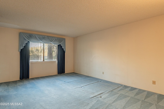 spare room with carpet floors and a textured ceiling