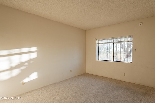 unfurnished room featuring a textured ceiling and carpet floors