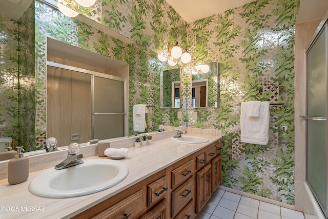 bathroom with vanity, an inviting chandelier, and tile patterned floors