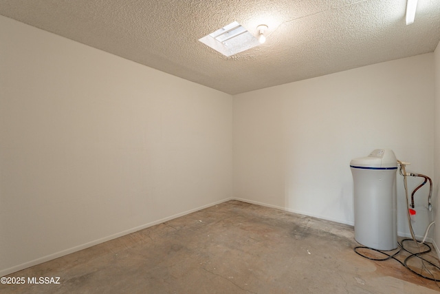 unfurnished room with a textured ceiling