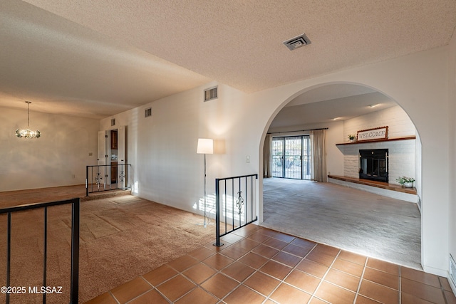 corridor featuring dark carpet and a textured ceiling