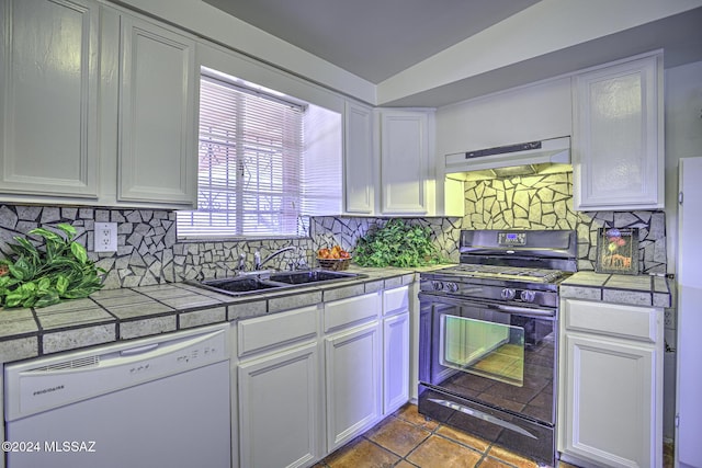 kitchen featuring white dishwasher, tile counters, gas stove, and sink