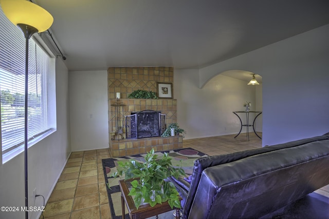 living room featuring a tiled fireplace