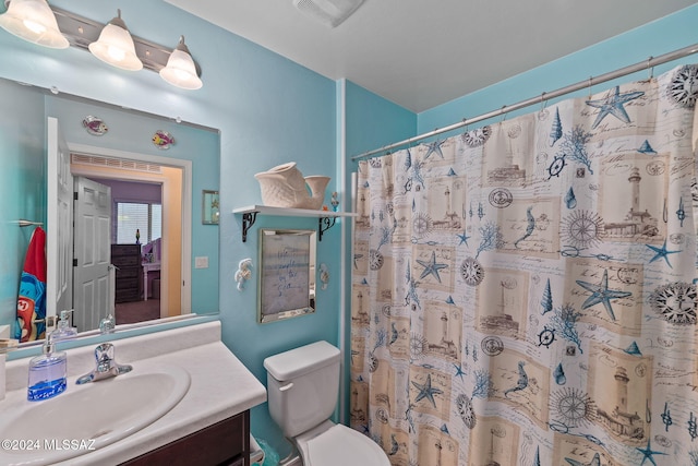 bathroom featuring a shower with curtain, vanity, and toilet