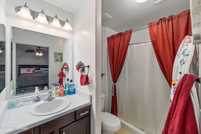 bathroom featuring ceiling fan, toilet, walk in shower, and vanity