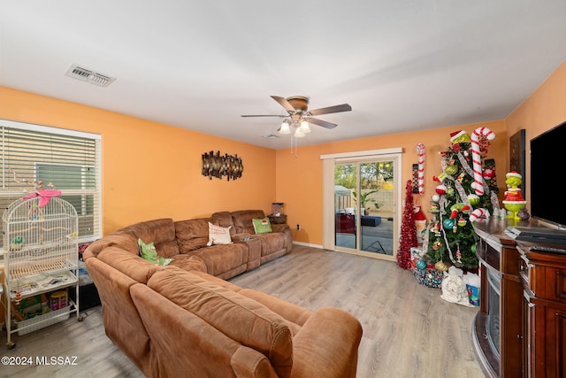 living room featuring ceiling fan and light hardwood / wood-style floors