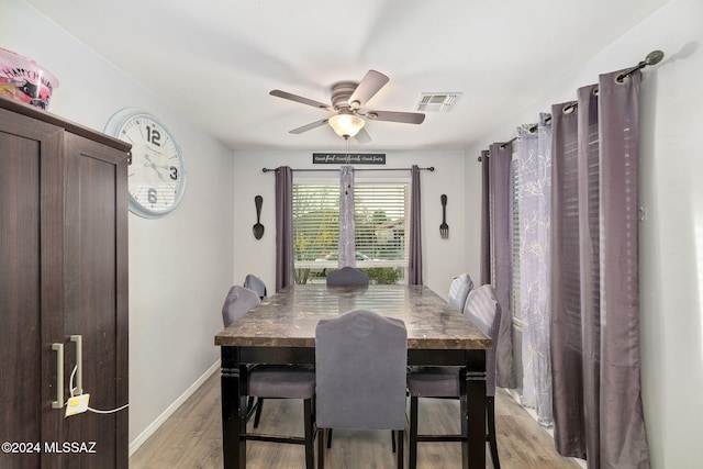 dining space featuring ceiling fan and light hardwood / wood-style flooring