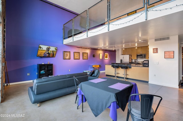 dining room with a high ceiling