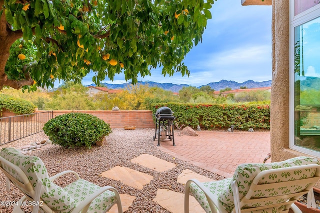 view of patio / terrace featuring a grill and a mountain view