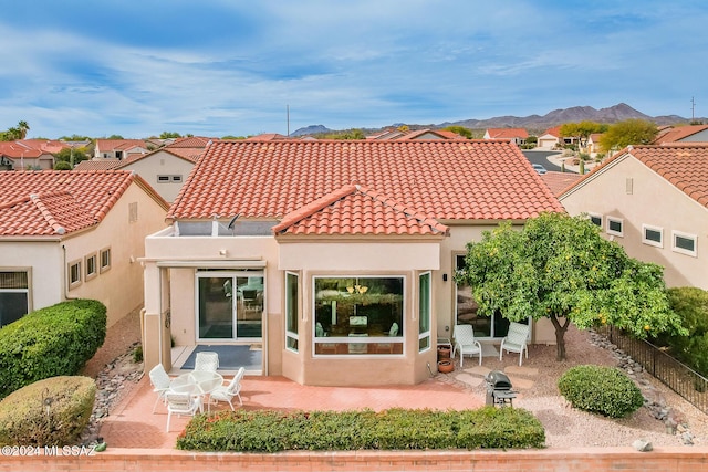 back of house featuring a mountain view and a patio