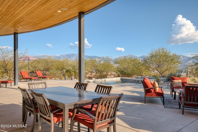 view of patio featuring a mountain view and a pool