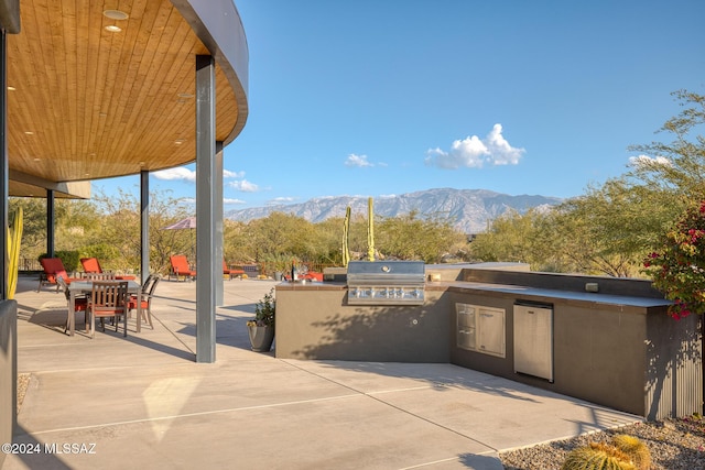 view of patio featuring a mountain view, area for grilling, and grilling area