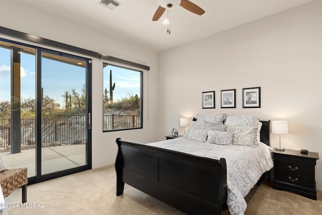 bedroom with light carpet, access to outside, and ceiling fan