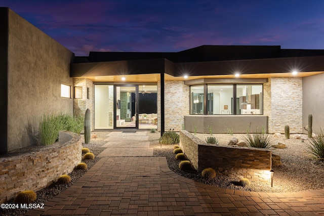 view of exterior entry at dusk