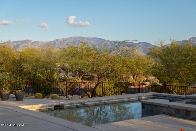 view of pool with a mountain view and a patio