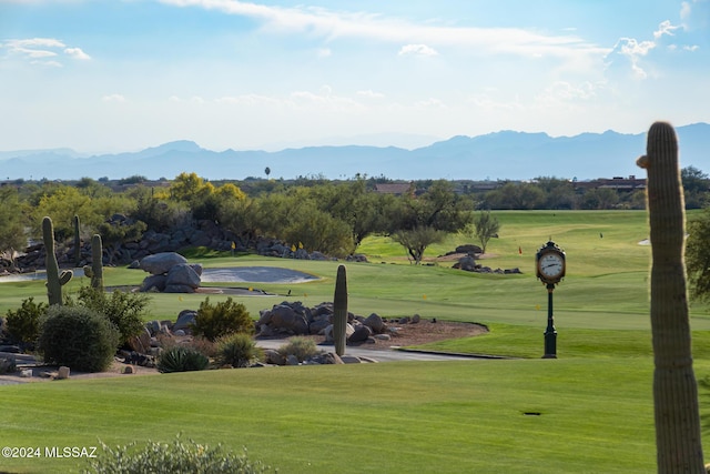 view of home's community featuring a mountain view and a yard