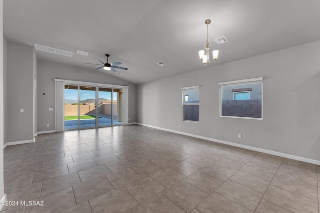 empty room with ceiling fan with notable chandelier, light tile patterned flooring, and vaulted ceiling