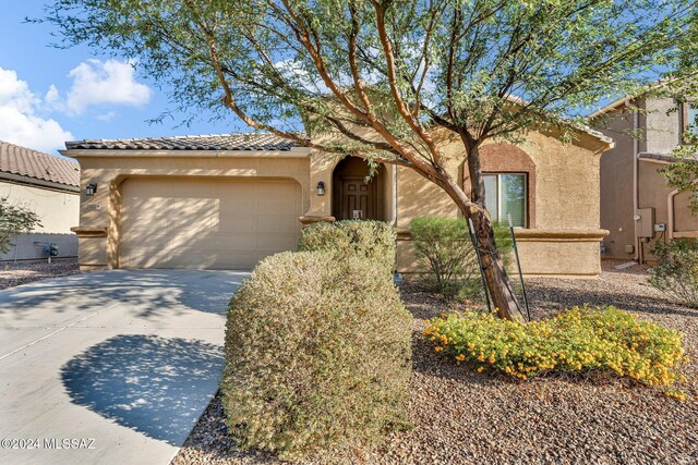 mediterranean / spanish-style home with a garage